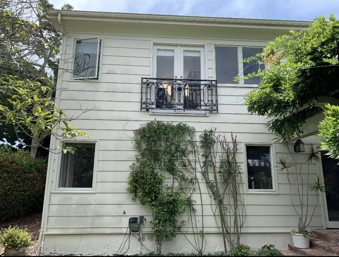 House exterior with visible buildup before washing